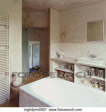 Stock Photo - View of a marble bathtub in a bathroom. Fotosearch