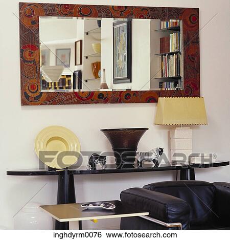 View of a mirror above a mantle in a living room View Large Photo Image Stock Photograph - View of a mirror above a mantle in a living room. Fotosearch