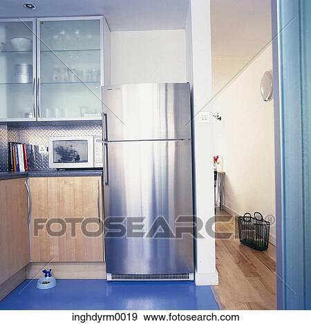 View of a modern kitchen with a steel finish fridge View Large Photo Image Stock Photo - View of a modern kitchen with a steel finish fridge. Fotosearch