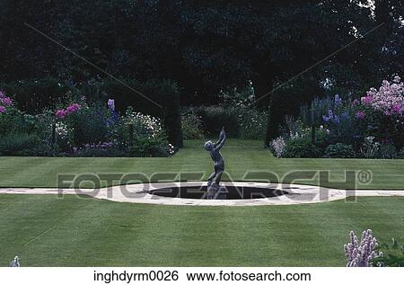 View of a statue in the center of a manicured garden View Large Photo Image Stock Photograph - View of a statue in the center of a manicured garden. Fotosearch