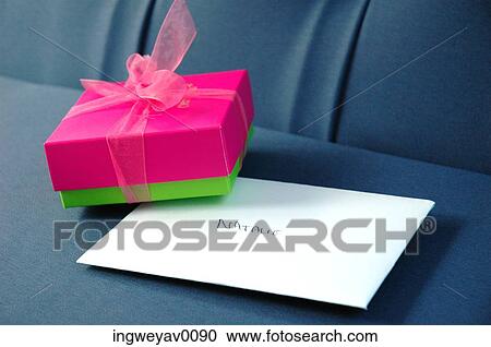 A gift box and a greeting card on a couch View Large Photo Image Stock Image - A gift box and a greeting card on a couch. Fotosearch