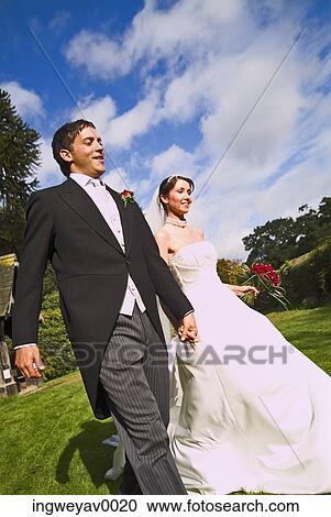 A newly married couple in a garden View Large Photo Image Stock Image - A newly married couple in a garden. Fotosearch