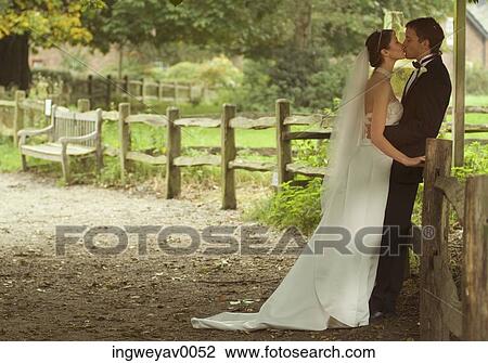 A newly married couple kissing each other on a farm View Large Photo Image Stock Image - A newly married couple kissing each other on a farm. Fotosearch