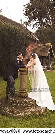 A newly married couple outside a church View Large Photo Image Stock Image - A newly married couple outside a church. Fotosearch