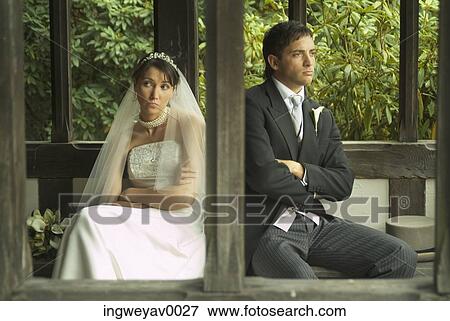 Stock Photo - A newly married couple sitting in a gazebo. Fotosearch