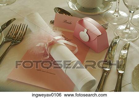 A paper scroll tied with a ribbon on a dinner table at a wedding party View Large Photo Image Stock Photograph - A paper scroll tied with a ribbon on a dinner table at a wedding party. Fotosearch
