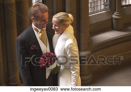 A young bride and groom in a church View Large Photo Image Stock Image - A young bride and groom in a church. Fotosearch