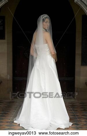 A young bride looking over her shoulder View Large Photo Image Stock Image - A young bride looking over her shoulder. Fotosearch