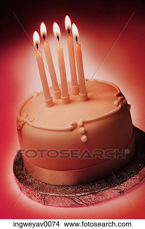 Close-up of a cake with five lit candles View Large Photo Image Picture - Close-up of a cake with five lit candles. Fotosearch