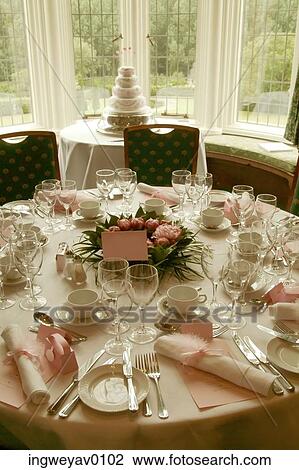 Close-up of a dinner table set with fine china and crystal glasses at a wedding party View Large Photo Image Stock Image - Close-up of a dinner table set with fine china and crystal glasses at a wedding party. Fotosearch