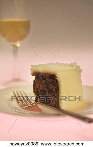 Close-up of a piece of cake and a glass of champagne View Large Photo Image Stock Photo - Close-up of a piece of cake and a glass of champagne. Fotosearch
