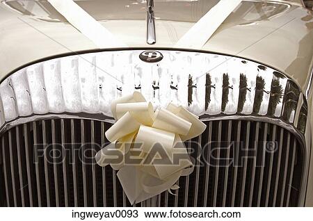 Stock Image - Close-up of a ribbon on the grill of a vintage car. Fotosearch