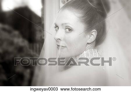 Stock Image - Close-up of a young bride looking over her shoulder ( black and white ). Fotosearch