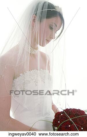 Close-up of a young bride wearing a veil View Large Photo Image Stock Image - Close-up of a young bride wearing a veil. Fotosearch