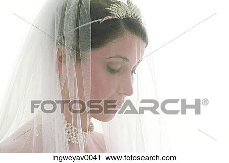 Close-up of a young bride wearing a veil View Large Photo Image Stock Image - Close-up of a young bride wearing a veil. Fotosearch