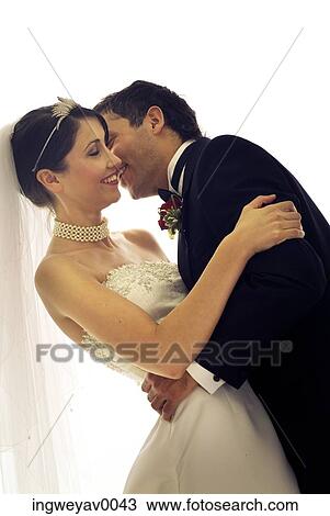 Close-up of a young groom kissing his bride View Large Photo Image Stock Image - Close-up of a young groom kissing his bride. Fotosearch