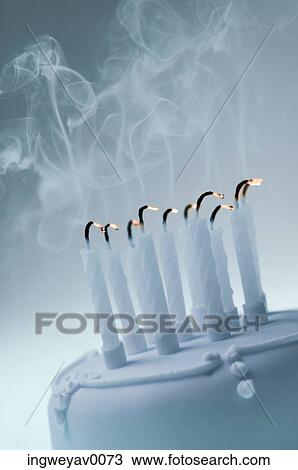 Close-up of extinguished candles on a cake View Large Photo Image Stock Image - Close-up of extinguished candles on a cake. Fotosearch