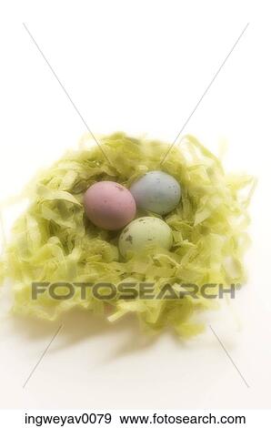 Close-up of three Easter eggs in a nest View Large Photo Image Stock Photo - Close-up of three Easter eggs in a nest. Fotosearch