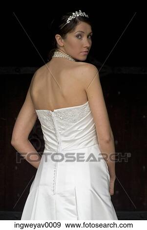 Stock Photo - Rear view of a young bride looking over her shoulder. Fotosearch