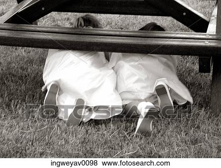 Two young bridesmaids crawling under a table View Large Photo Image Stock Photo - Two young bridesmaids crawling under a table. Fotosearch
