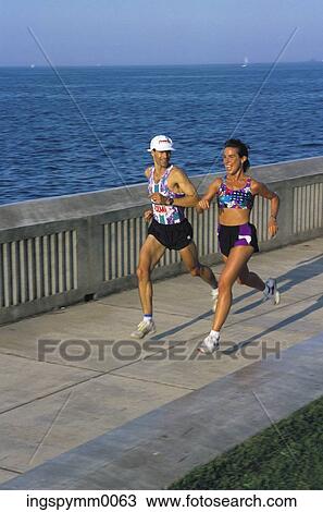A couple jogging at the sea front View Large Photo Image Stock Image - A couple jogging at the sea front. Fotosearch