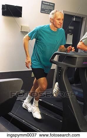 A senior man running on a treadmill in a gym View Large Photo Image Stock Photo - A senior man running on a treadmill in a gym. Fotosearch