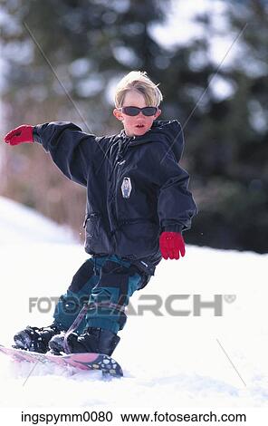 A young boy snowboarding down a slope View Large Photo Image Stock Image - A young boy snowboarding down a slope. Fotosearch