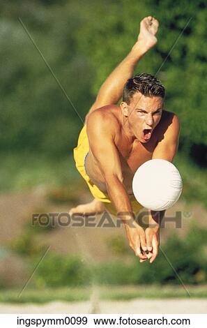 A young man jumping in midair, playing volleyball View Large Photo Image Stock Photo - A young man jumping in midair, playing volleyball. Fotosearch