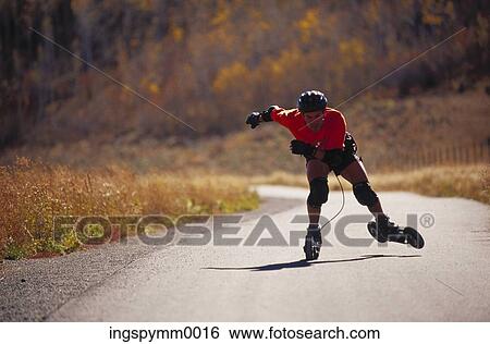 A young man skating on a street View Large Photo Image Stock Photograph - A young man skating on a street. Fotosearch