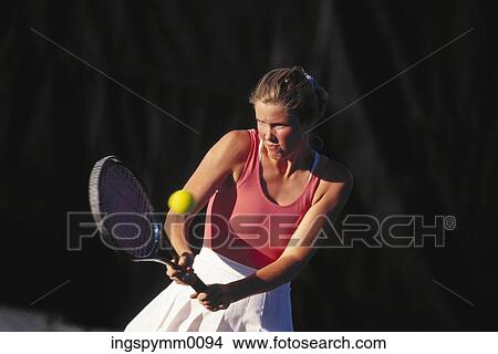 A young woman playing lawn tennis View Large Photo Image Picture - A young woman playing lawn tennis. Fotosearch