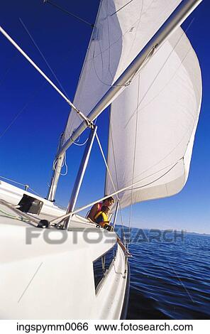 A young woman with a young boy on a sail boat at sea View Large Photo Image Stock Photograph - A young woman with a young boy on a sail boat at sea. Fotosearch