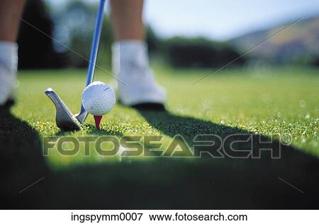 Close-up of a golf club near a golf ball on a tee View Large Photo Image Stock Photo - Close-up of a golf club near a golf ball on a tee. Fotosearch
