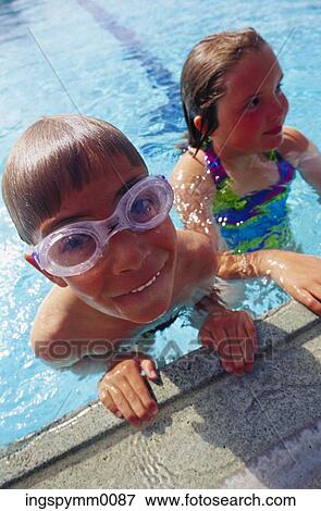 Close-up of a young boy and a young girl in a swimming pool View Large Photo Image Stock Photo - Close-up of a young boy and a young girl in a swimming pool. Fotosearch