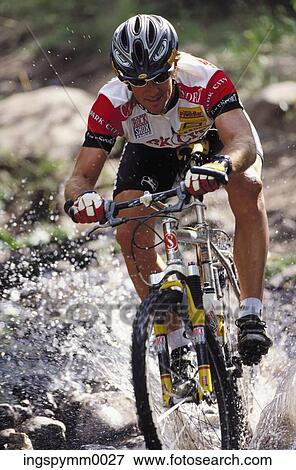 Close-up of a young man cycling in a stream View Large Photo Image Stock Photo - Close-up of a young man cycling in a stream. Fotosearch