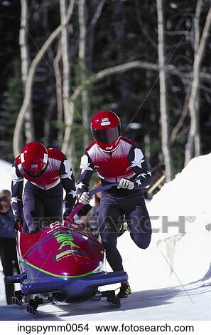 Close-up of men in a bobsled race View Large Photo Image Picture - Close-up of men in a bobsled race. Fotosearch