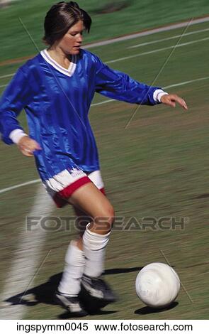 Female football player with the ball during a game View Large Photo Image Stock Photography - Female football player with the ball during a game. Fotosearch