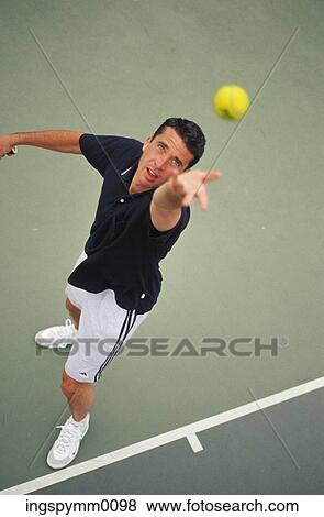 High angle view of a man serving at a tennis match View Large Photo Image Stock Photo - High angle view of a man serving at a tennis match. Fotosearch