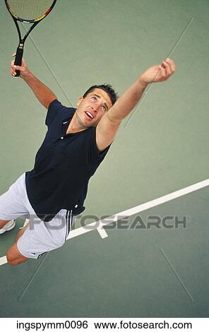 High angle view of a man serving at a tennis match View Large Photo Image Stock Photograph - High angle view of a man serving at a tennis match. Fotosearch