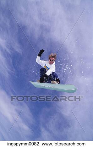 Low angle view of a snow boarder in midair View Large Photo Image Stock Image - Low angle view of a snow boarder in midair. Fotosearch