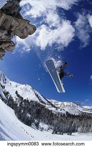 Low angle view of a snowboarder jumping off a slope View Large Photo Image Stock Image - Low angle view of a snowboarder jumping off a slope. Fotosearch