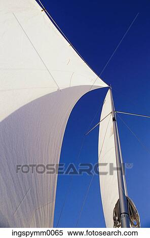 Low angle view of the sails of a yacht View Large Photo Image Stock Photography - Low angle view of the sails of a yacht. Fotosearch