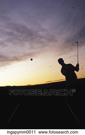 Stock Image - Silhouette of a man playing golf. Fotosearch
