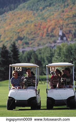 Two couples riding golf carts View Large Photo Image Stock Photo - Two couples riding golf carts. Fotosearch