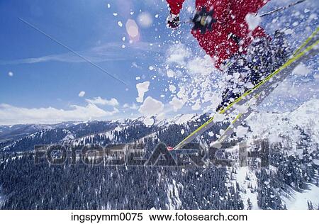 View of a skier throwing up snow while skiing on a mountain View Large Photo Image Stock Photography - View of a skier throwing up snow while skiing on a mountain. Fotosearch