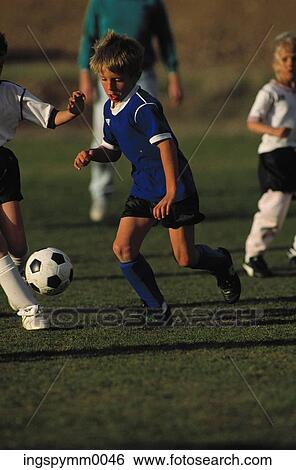 Young boys and girls playing football View Large Photo Image Stock Photograph - Young boys and girls playing football. Fotosearch