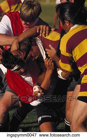 Young male football players in a tackle during a game View Large Photo Image Stock Photo - Young male football players in a tackle during a game. Fotosearch