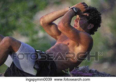 Young man exercising outdoors View Large Photo Image Stock Photo - Young man exercising outdoors. Fotosearch