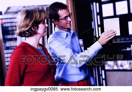 A mid adult couple talking to each other near a window View Large Photo Image Stock Photography - A mid adult couple talking to each other near a window. Fotosearch