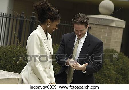 Businessman and businesswoman standing, talking outdoors View Large Photo Image Stock Photo - Businessman and businesswoman standing, talking outdoors. Fotosearch