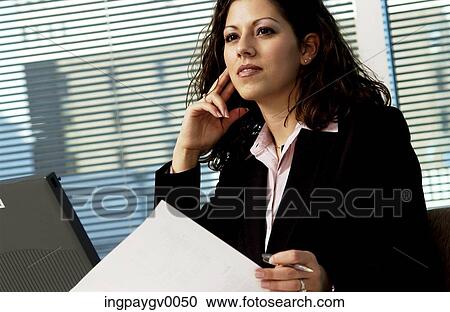 Businesswoman sitting in front of a laptop View Large Photo Image Stock Image - Businesswoman sitting in front of a laptop. Fotosearch